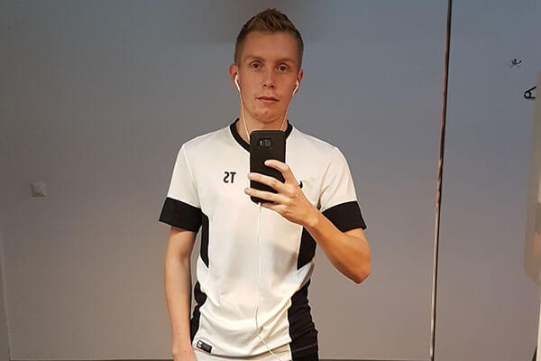 Sehr dünner Mann im weißen Shirt macht ein Selfie vor einem Spiegel.
